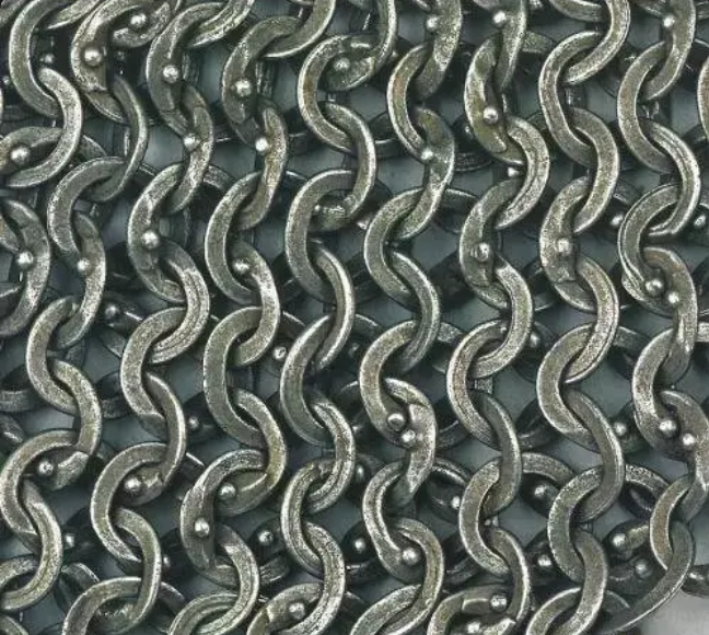 Close-up of interlocking metal rings in ring-linked armor construction