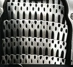 Small overlapping armor plates with perforations and lacing