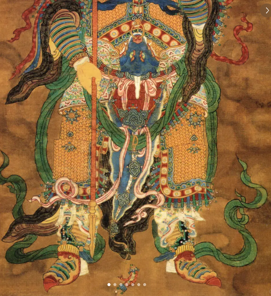 Fish-tail groin guard hanging from the center of a divine warrior's armor
